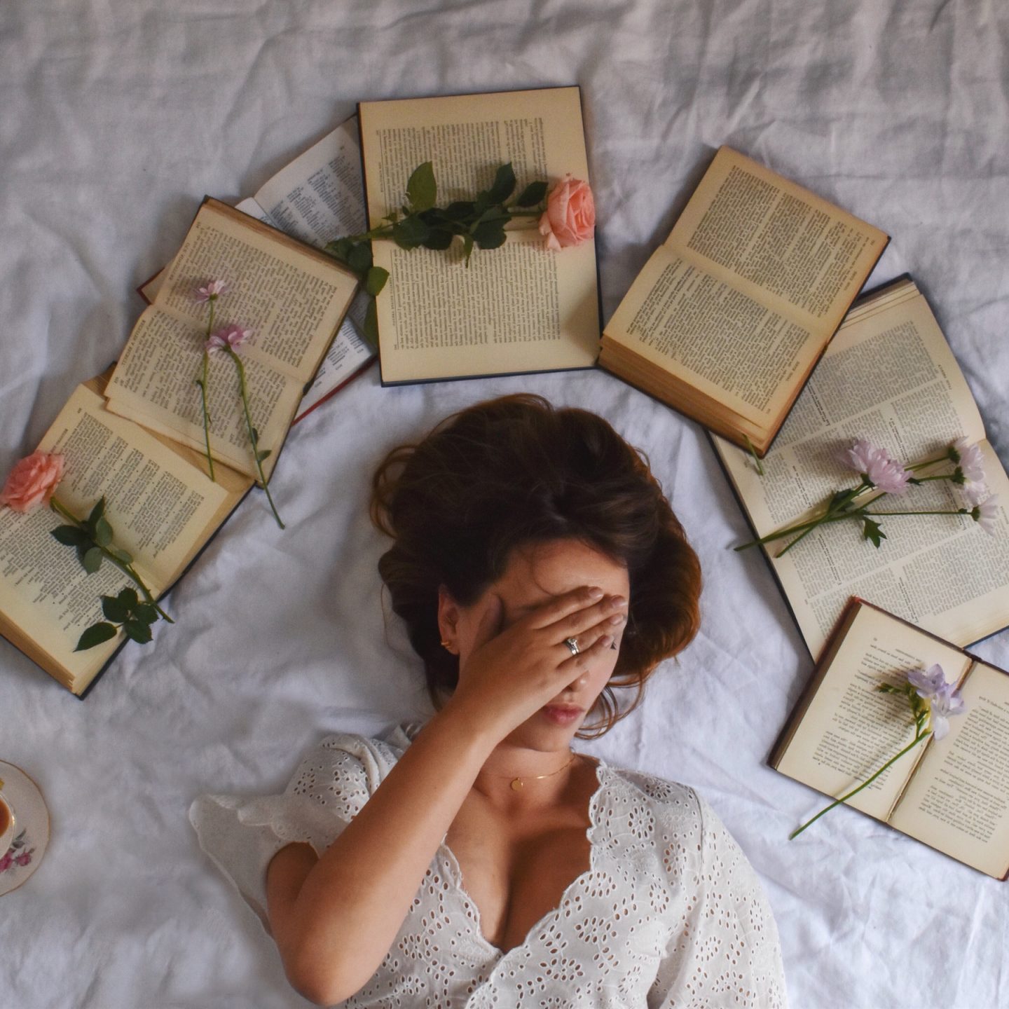Photo of books, flowers and woman